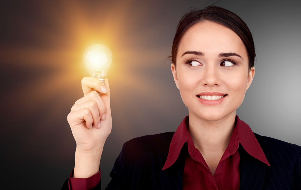A woman holding a lightbulb, to depict that she had an idea