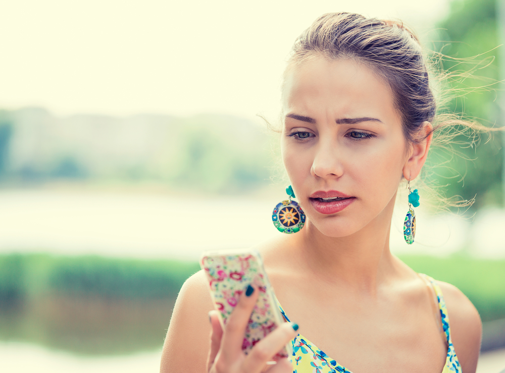 Woman looking at her iPhone.
